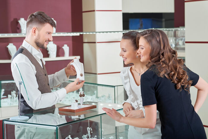 Jewelry store scene with multilingual customers and salesman, showcasing stories of catching folks gossiping in secret languages.