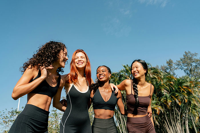 Group of four women enjoying outdoor group activities, highlighting challenges faced by a mom of 4 with kids.