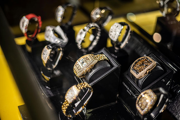 Luxury watches on display case, symbolizing red flags women notice after ending relationships.