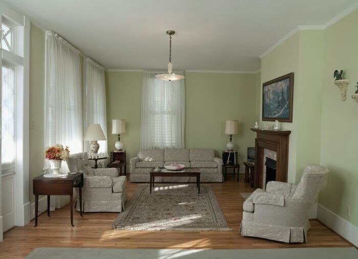 Living room with vintage furniture and soft lighting, illustrating 52 things Americans ask if actually true in real life.