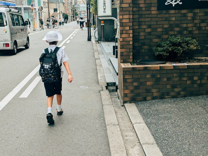 Young boy walking alone on a city street, symbolizing moments related to near-death experiences witnessed.