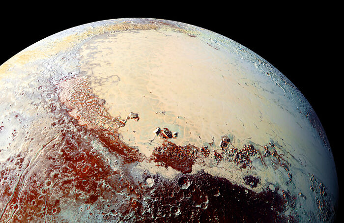 Close-up epic astronomy photo of Pluto's icy surface showing intricate geological features in the mystery of space.