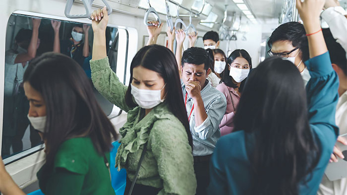 Young people wearing masks in crowded subway, illustrating clueless moments and reactions in public transportation.