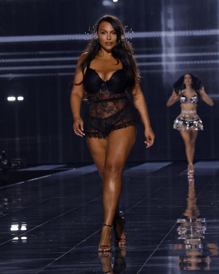Model walking runway in black lace lingerie and heels during Victoria's Secret fashion show 2025 stunning runway looks.
