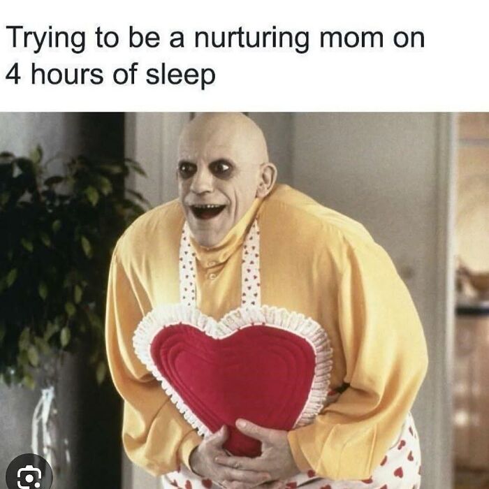 Tired parent wearing a heart apron, humorously portraying the chaos and lack of sleep in parenting life.