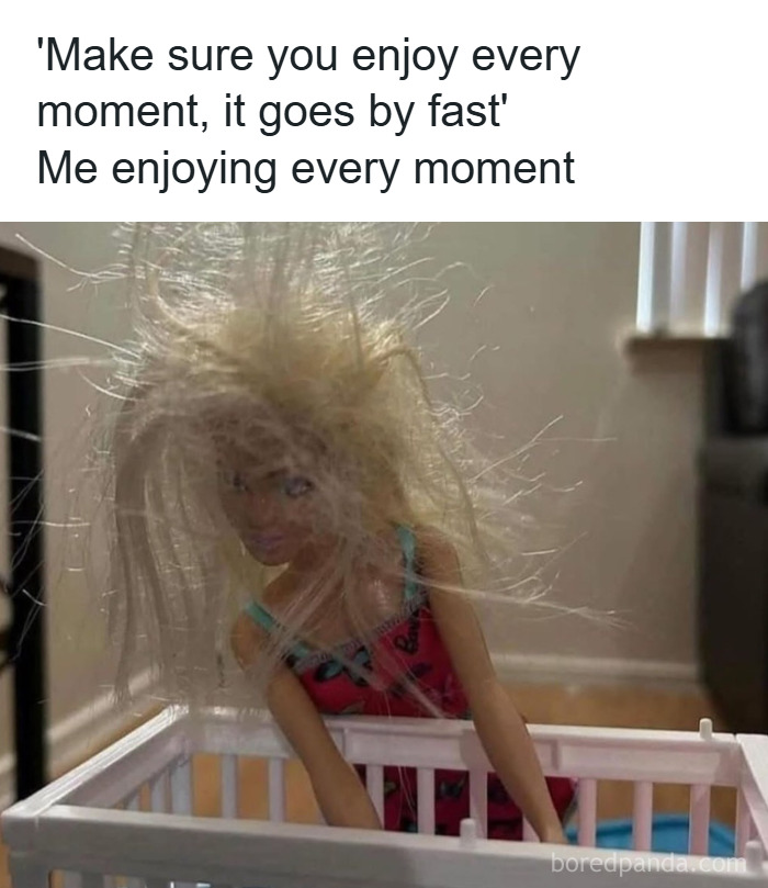 Messy-haired doll in a crib illustrating the chaos and exhaustion of parenting with love and laundry.