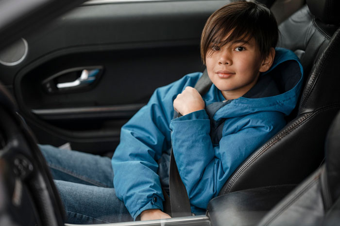 Teen wearing a blue jacket sitting alone in a car, representing parents kicked out teen facing a tough situation. Teen wearing a blue jacket sitting alone in a car, representing parents kicked out teen facing a tough situation.