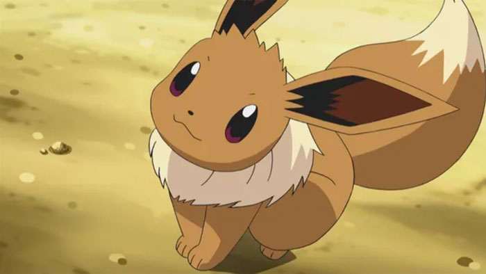 Cute Eevee Pokémon sitting on sandy ground, representing parents sharing baby names they regret giving to their kids.