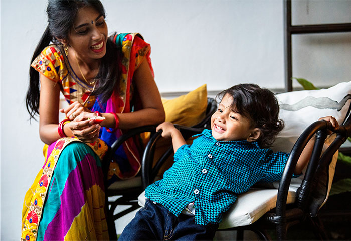 Mother and toddler boy smiling and spending time together, illustrating baby names parents regret giving.