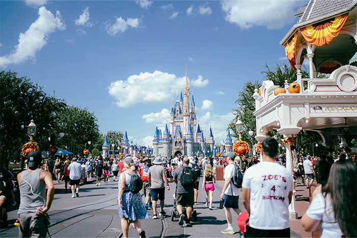 Crowd of parents and families visiting a theme park, illustrating baby names parents regret giving to their kids.