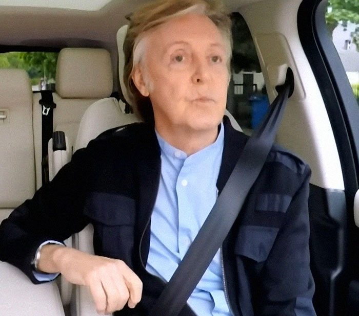 Man wearing a seatbelt in a car, captured during a casual celebrity encounter for sharing memorable celebrity stories.