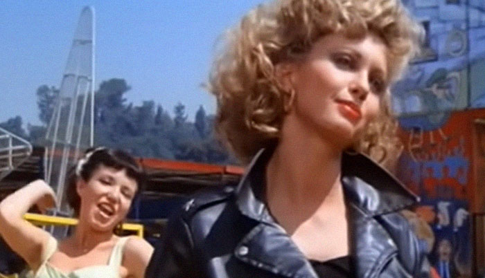 Two women outdoors, one wearing a leather jacket, capturing a moment related to encounters with celebrities.