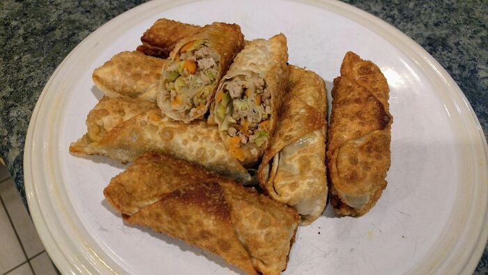 Plate of fried spring rolls with mixed vegetables and meat filling, illustrating foods not popular in their country despite tourist expectations.