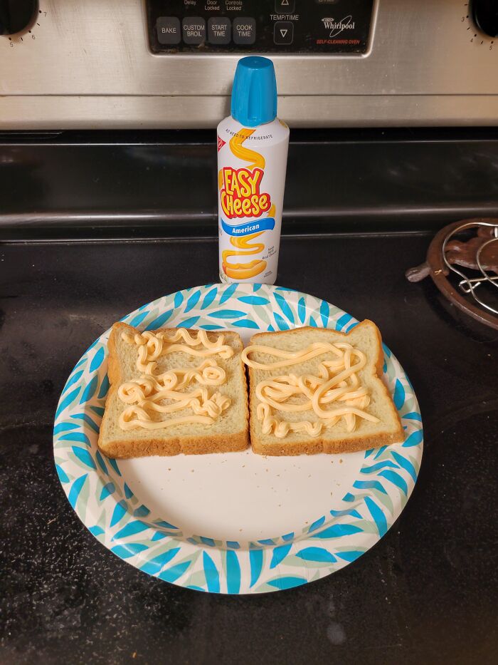 Two slices of bread with easy cheese spread on a plate, illustrating unpopular foods in some countries tourists expect to enjoy.