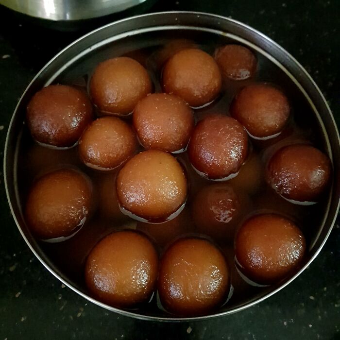 Traditional Indian dessert gulab jamun soaking in syrup, illustrating foods not popular in their country despite tourist expectations