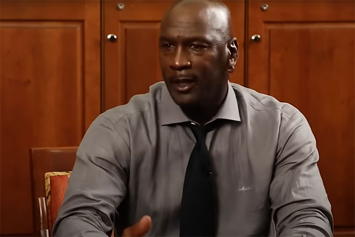 Man in a gray shirt and black tie sharing a story about celebrity encounters that left a sour taste in people’s mouths.