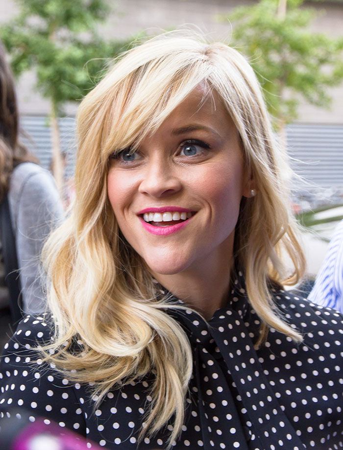 Blonde woman smiling outdoors at a public event, illustrating celebrity encounters that left a sour taste.