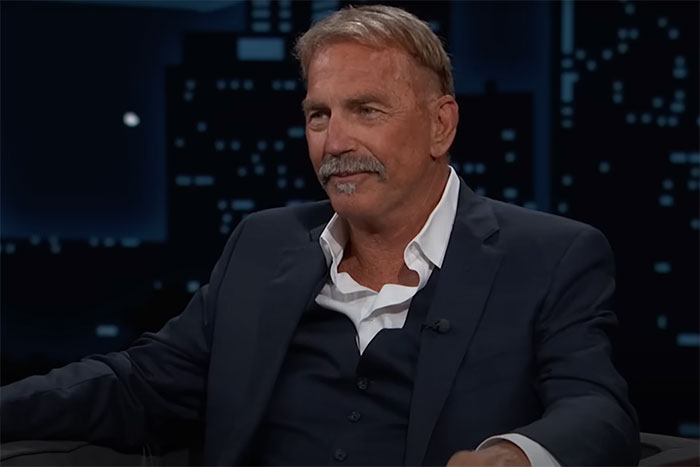 Man in a dark suit sharing a celebrity encounter story that left a sour taste in people's mouths during a TV interview.