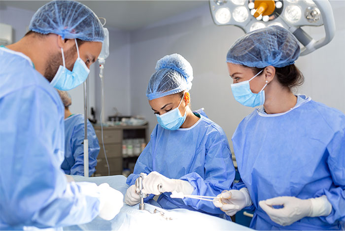 Surgical team wearing masks and scrubs performing an operation highlighting stories of waking up during surgery.