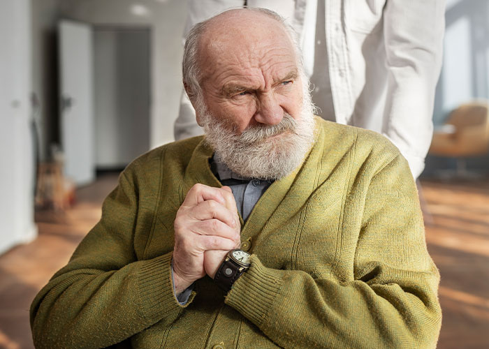 Older man looking distressed while sitting in a wheelchair, reflecting themes of how to ruin your entire life mistakes.