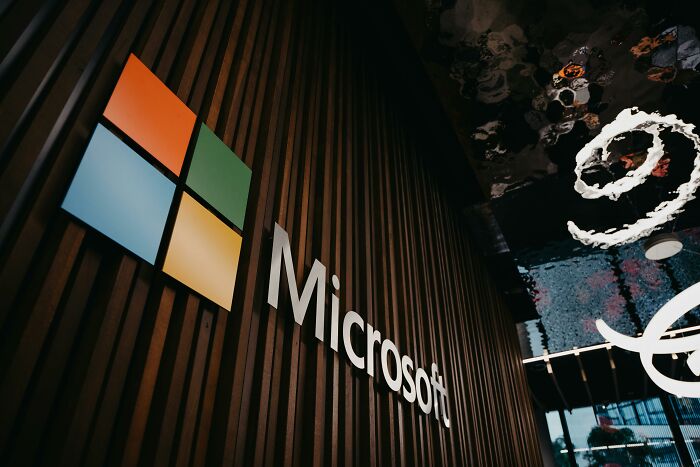 Microsoft logo on a wooden wall with reflections above, related to savage responses from the internet brand game.