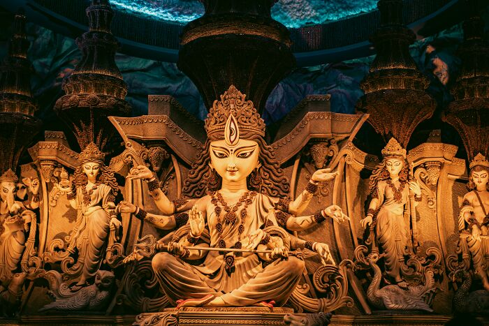 Intricate statue of a goddess with multiple arms, symbolizing chaos and drama in breakup stories.