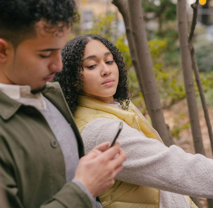 Woman looks concerned as she learns the man she&rsquo;s been seeing for months is getting married soon outdoors.