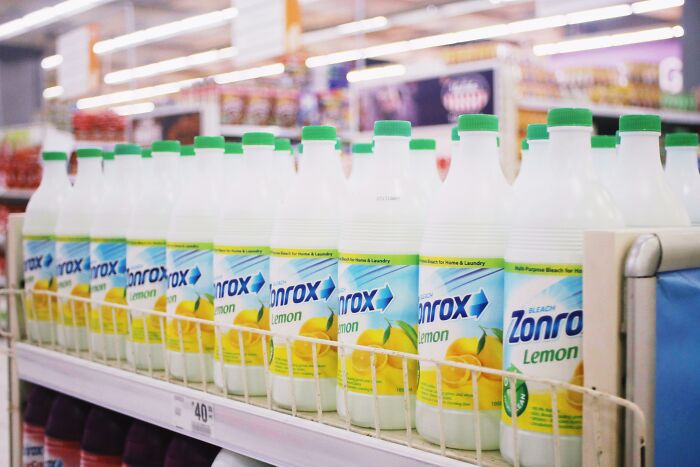Bottles of bleach lined up on a store shelf, illustrating people share potentially dangerous situations with cleaning products.