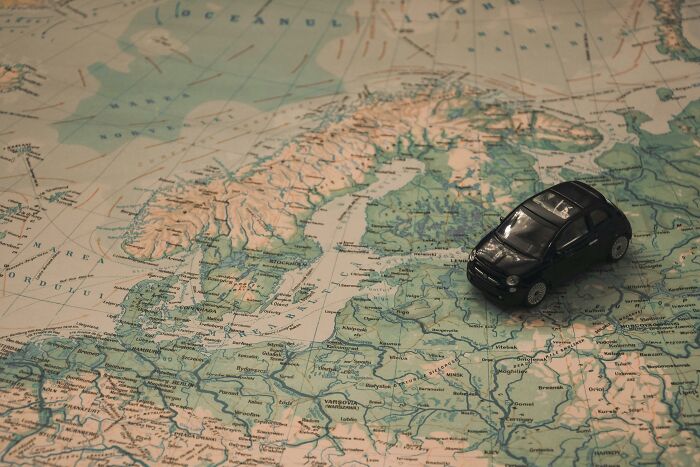 Toy car placed on a detailed map of Europe, highlighting countries and borders, perfect for mastering Europe's map skills.