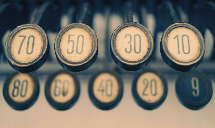 Close-up of vintage typewriter keys showing numbers, representing history buffs typing correct numbers for iconic events.