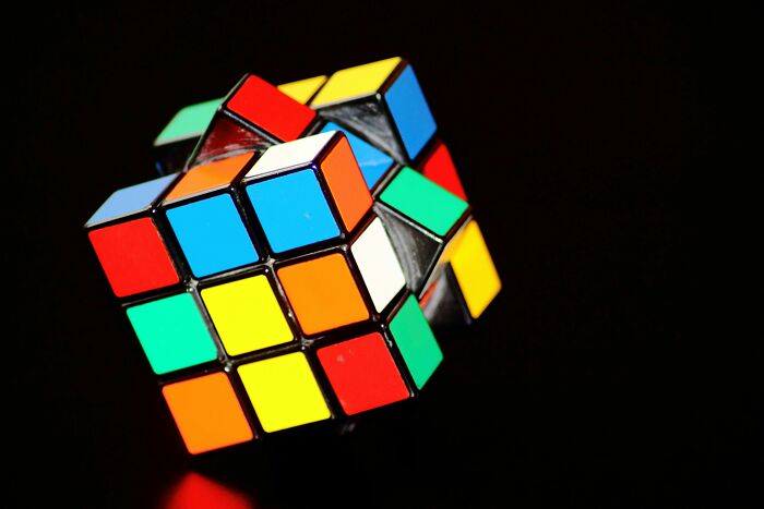 Partially solved Rubik's Cube against black background, highlighting pattern-spotting skills for IQ challenge.