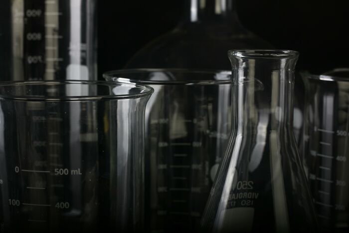 Close-up of various laboratory glassware with liquid measurements, illustrating people share potentially dangerous situations in experiments.