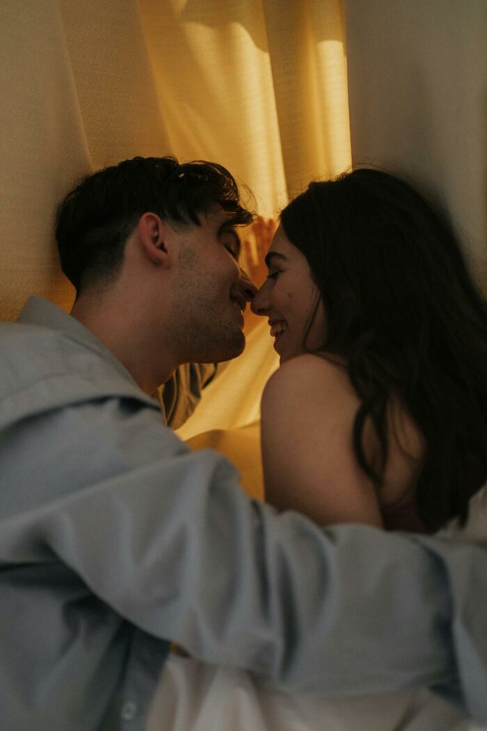 Couple sharing an intimate moment, smiling closely in warm light, illustrating online dating advice and connection experience.