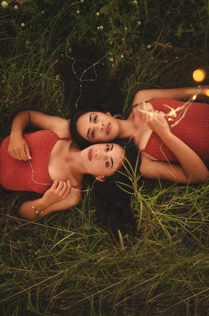 Two women lying in grass at sunset, symbolizing relationships and reflecting on spouses changing after the wedding red flags ignored.