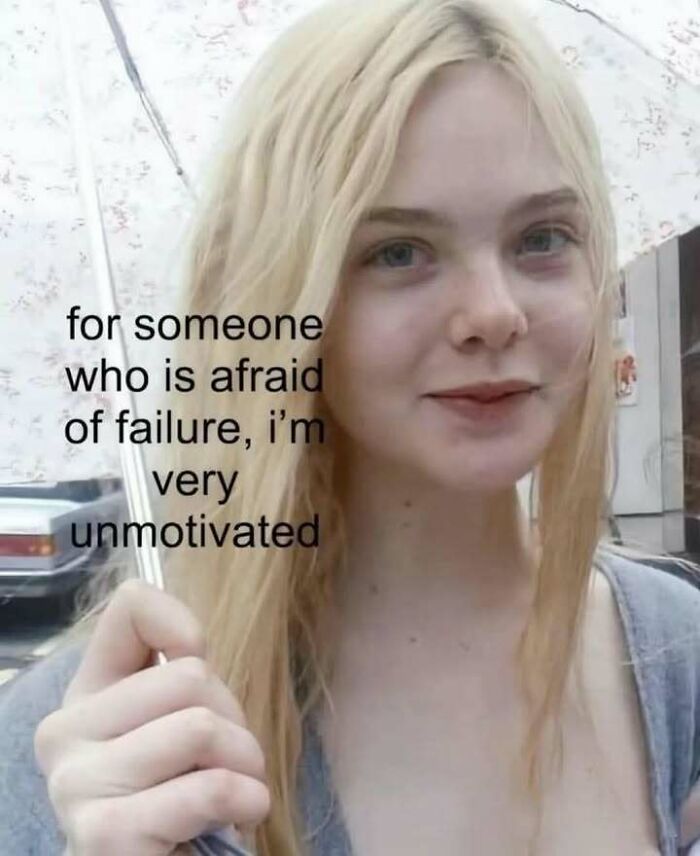 Young woman with blonde hair holding an umbrella, accompanied by a meme about evil thoughts and lack of motivation.