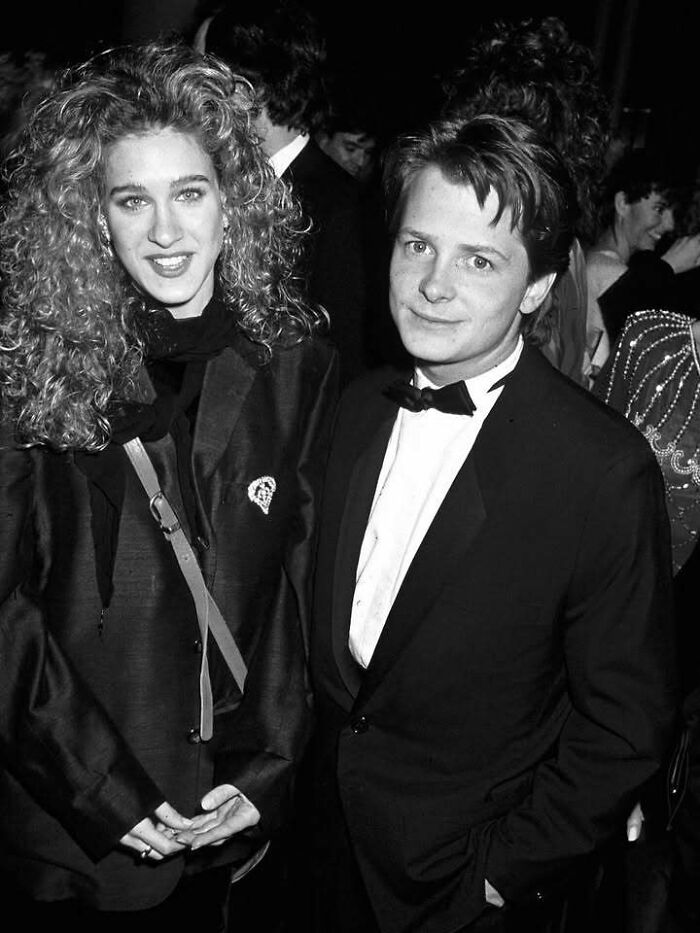 Two people dressed elegantly at a formal event, representing influential figures in the movie and music industries.