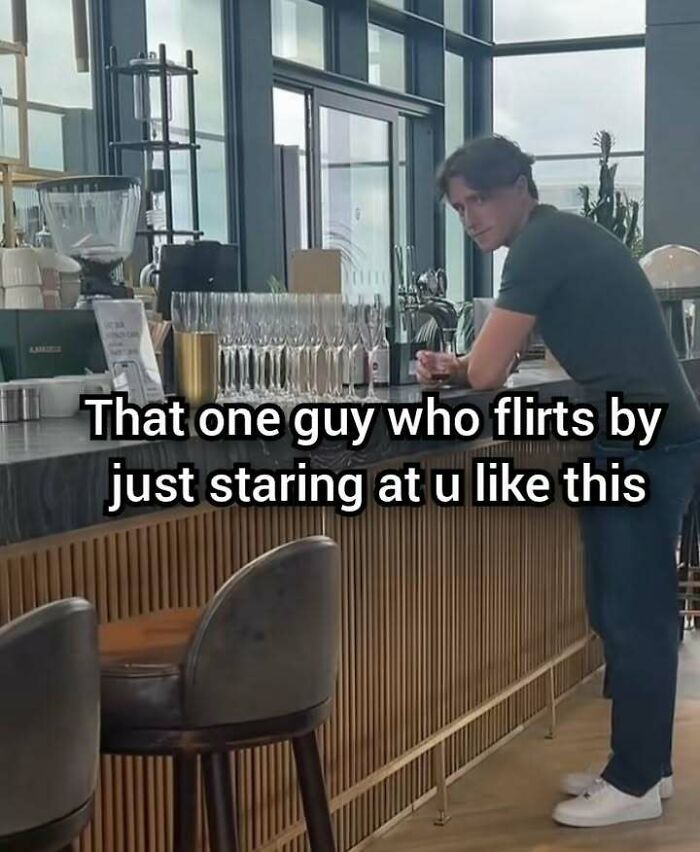 Man leaning on bar counter staring intensely, evoking evil thoughts meme and unhinged humor vibes.