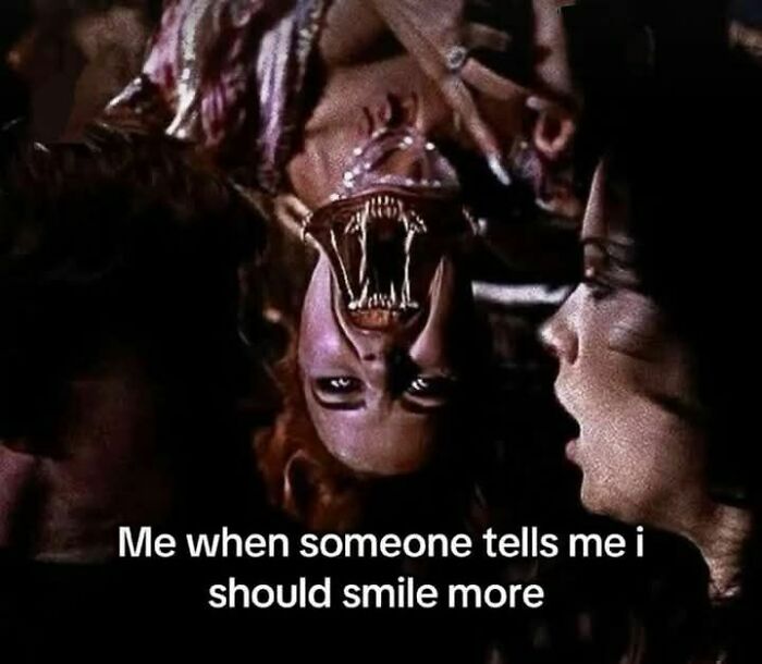 Upside-down woman with a monstrous mouth, captioned about smiling, illustrating evil thoughts in a dark meme style.