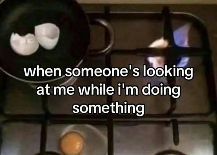 Frying pan with eggs cooking on a stove, featuring a meme about feeling watched, tied to evil thoughts memes.