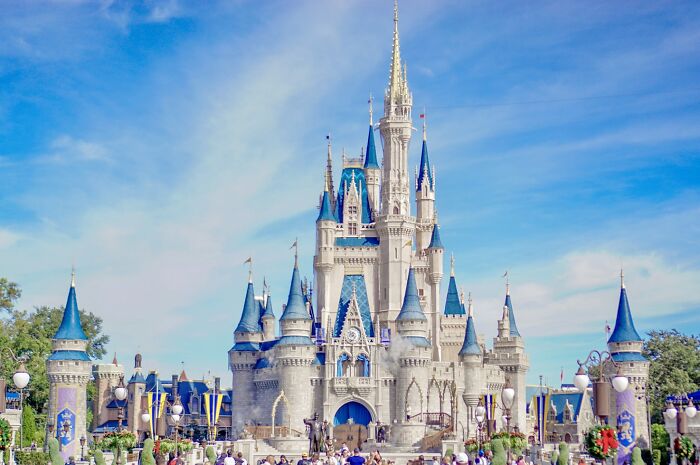 Disney castle under a clear sky, illustrating a backdrop for people sharing chaotic and dramatic breakup stories.