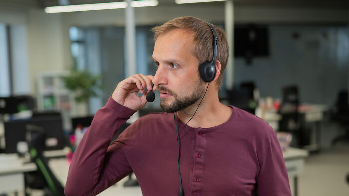 911 operator wearing headset handling one of the strangest calls received that turned out to be true in an office setting