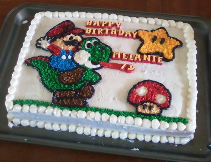 Birthday cake decorated with colorful icing characters from Mario, showcasing detailed bakery cake design and decoration.