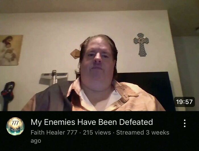 A faith healer in a casual shirt streaming a spiritual message about enemies being defeated in an occult context.