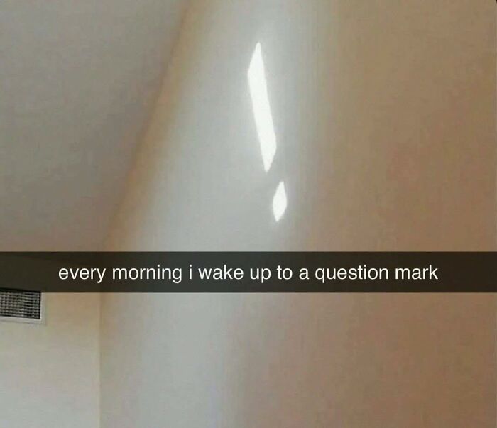 Light reflection on wall resembling a question mark, illustrating pleasures of the occult in a funny out of context way.