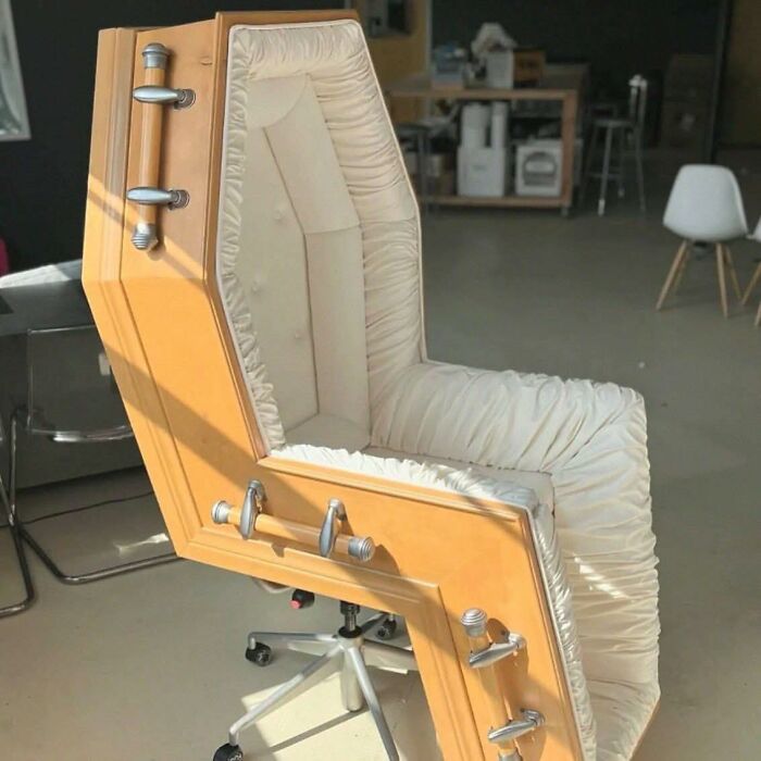 Unique coffin-shaped office chair with cushioned interior combining pleasures of the occult and modern furniture design.