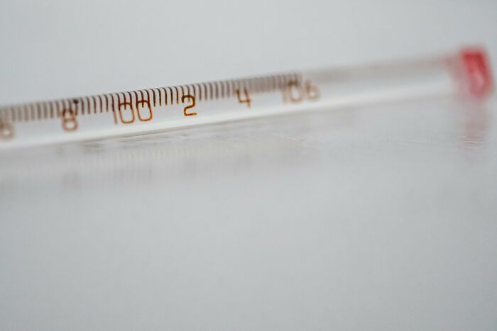 Close-up of a glass thermometer showing temperature details, illustrating concept of luck or happiness choices.