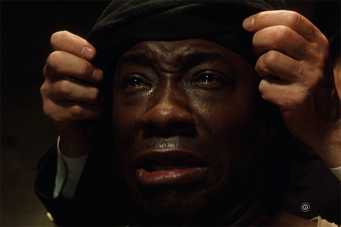 Emotional close-up of a man with tears in his eyes, capturing heartstring tugging moments from movies.