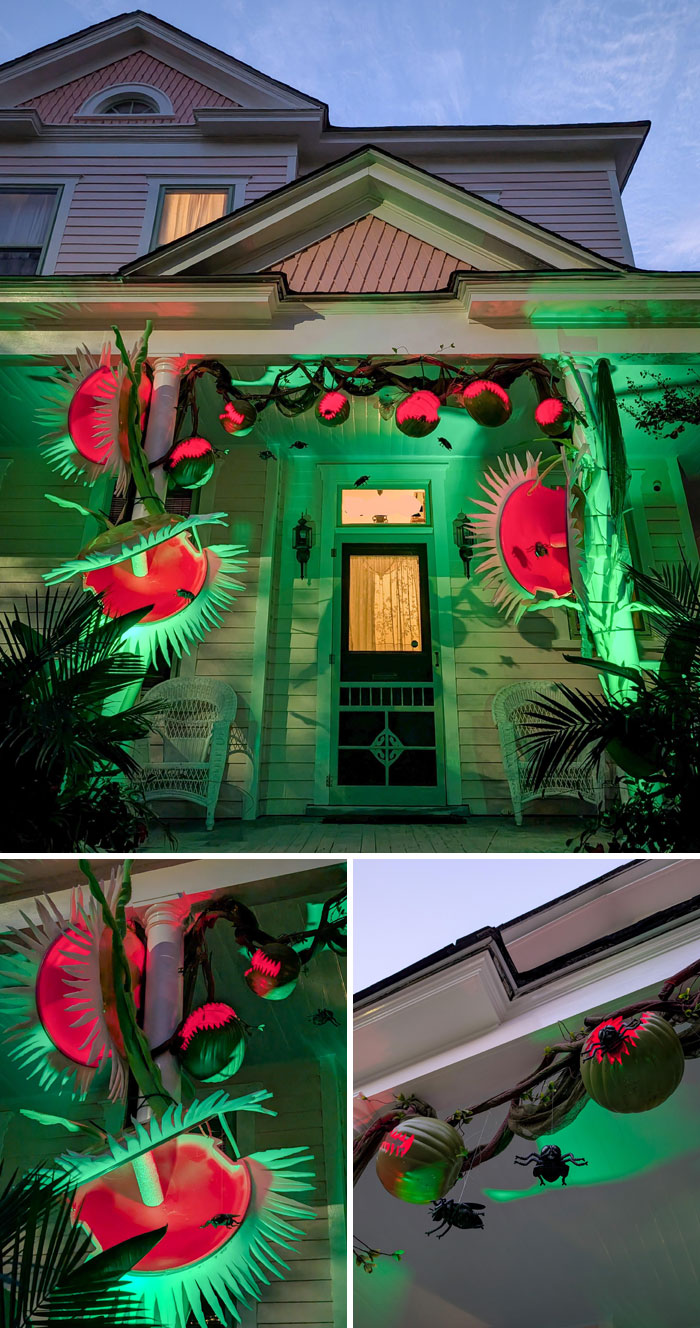 Outdoor Halloween decorations with glowing carnivorous plants and hanging pumpkins lit in green and red on a house porch.