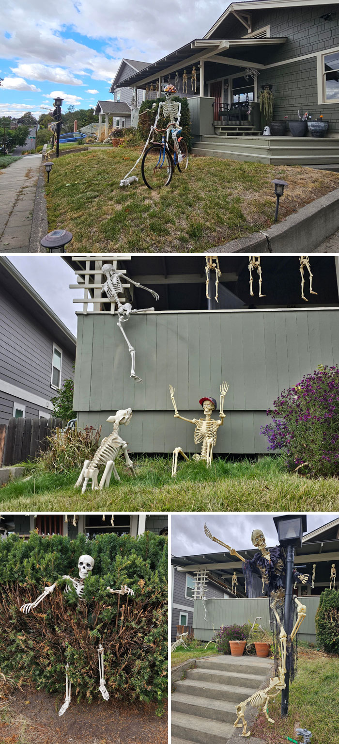 Outdoor Halloween decorations featuring skeletons in creative poses around a house yard on a cloudy day.
