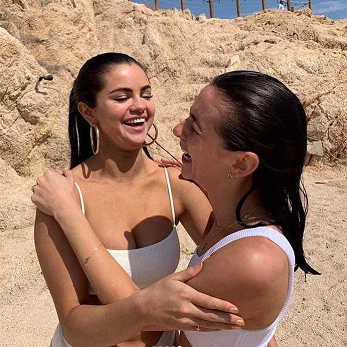 Selena Gomez and woman who donated her a kidney sharing a joyful moment outdoors near rocky terrain.